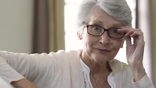 Happy Retired Senior Woman Looking at Camera While Holding Eyeglasses. Smiling Satisfied