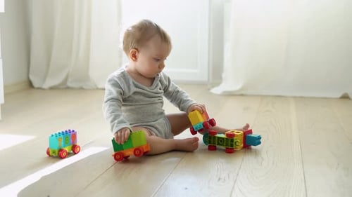 Baby Playing with Toy Blocks on Floor