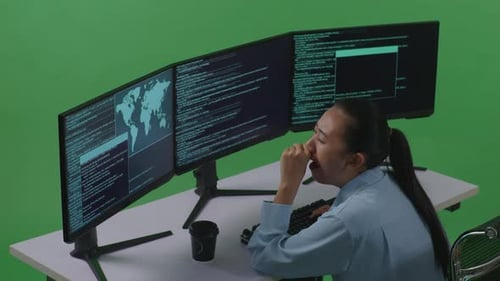 Tired Asian Woman Yawning Before Sleeping While Write Code With Multiple Screens In Green Screen