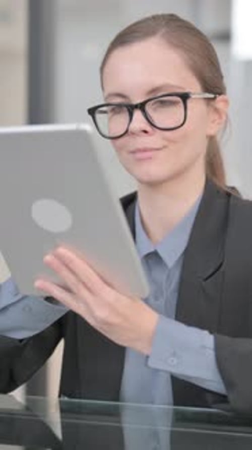 Businesswoman Working on Digital Tablet in Office, vertical video