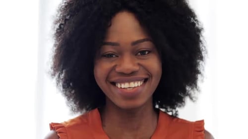 Happy woman smiling looking at camera close up