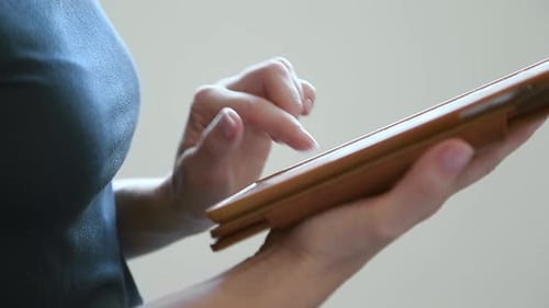 Close Up of Female Hands Using Tablet Computer Browsing Internet Working Online Researching