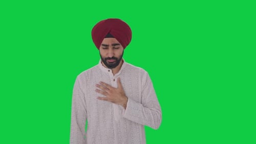 Sick Sikh Indian man suffering from fever Green screen