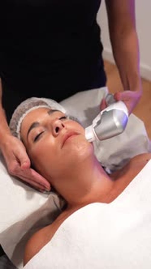 Woman Receiving Facial Treatment at a Beauty Salon