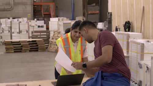 Colleagues Discussing Work in Distribution Warehouse Adult