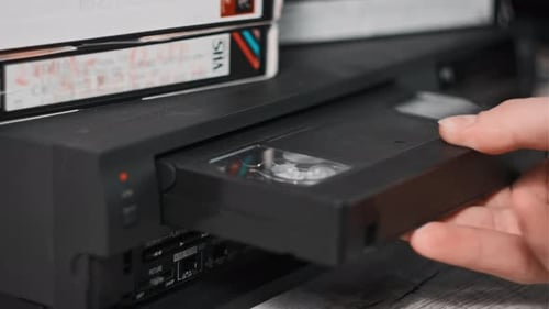 Insert VHS Cassette Into VCR Player and Push Play Button