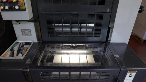 Industrial printer uploads white paper, ready to print