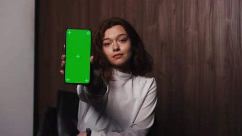 Woman Holding Mobile Phone Green Screen Female Shows Smartphone Chroma Key Smiling Lady Looking at