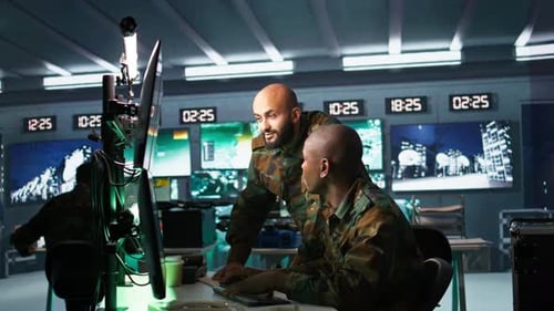 Men Monitor Computer Screens in Futuristic Command Center