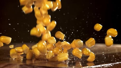 Canned Corn Falls on a Wooden Plank Filmed on a Highspeed Camera at 1000 Fps