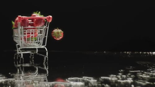 Small Shopping Carts with Fresh Strawberries Rolling on Table