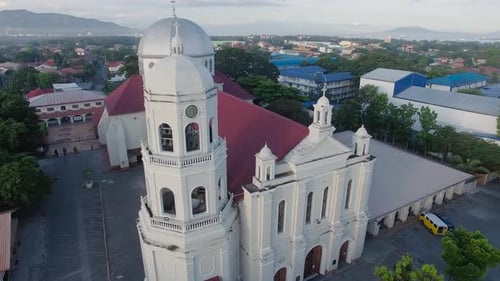 A glowing shiny majestic landscape rotating drone view over a Basilica Church of the city having riv