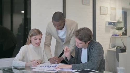 Mixed Race People Discussing Work in Office