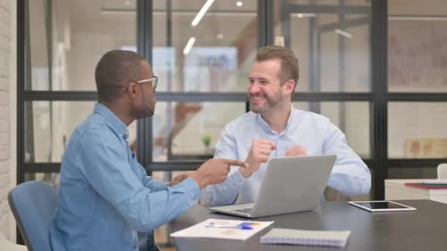 Excited Business People Celebrating Success in Office