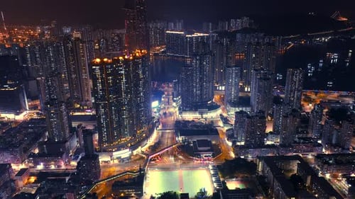 Hyperlapse of traffic moving between the high-rise buildings of Tuen Mun during night time, Hong Kon