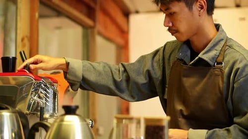 Male Barista Making Latte at Coffee Shop