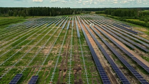 Photovoltaic Panels Mounted On Field. Solar Power Plant. drone shot