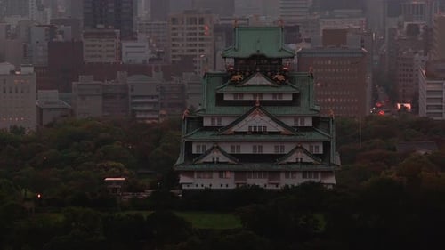 Aerial View of Osaka Castle and Urban Skyline at Twilight