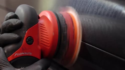 Closeup view of male hand. Auto coating quality control. Measuring paint cover thickness of the car