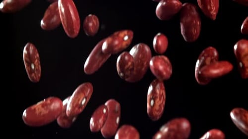 Kidney Beans Falling in Slow Motion Against Black