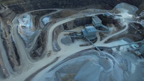 Aerial view of heavy in a quarry. Industrial excavation site with diggers