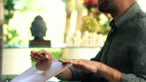 Young Man Finishing Working on Laptop, Drinking Coffee in Garden 30s