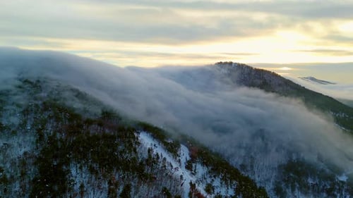 Golden Clouds Over Misty Mountain Peaks 4K