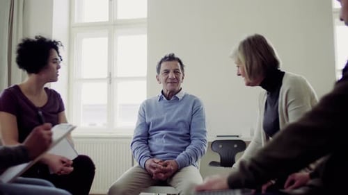 Men and Women Sitting in a Circle During Group Therapy, Talking