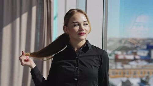 Blonde Woman Posing by Window in a High Rise