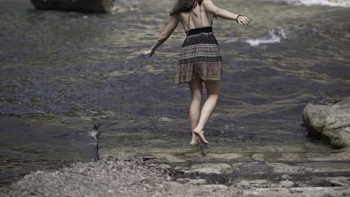 Young Spanish Girl Video Walking Carefully Next to an Island's Bay in Slowmotion
