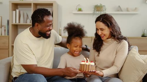 Happy Family Celebrating Birthday with Cake at Home