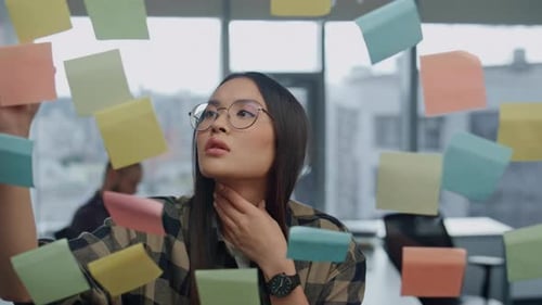 Thoughtful Freelancer Pondering Sticker Wall Office Closeup