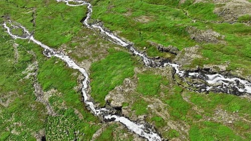 River Flows Through Mountains in Summer Season Waterfalls on Hills in Iceland