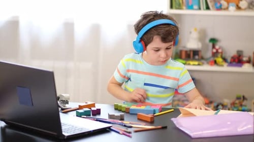 Focused Boy Studying at Desk Indoors