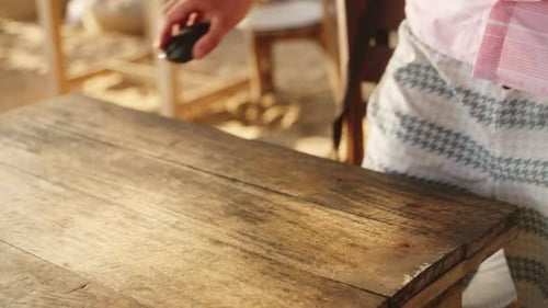 Freelancer configura laptop em mesa rústica de madeira em Beach Cafe Man inicia trabalho remoto com Ocean