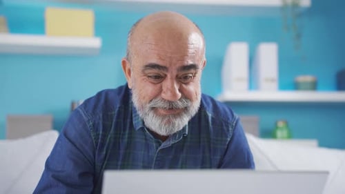 Senior Man Communicating on Video Call at Home