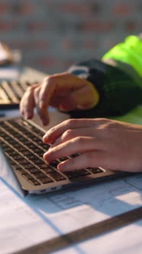 Construction, hands and laptop with man on building site for planning or property development