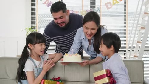 Family Celebrates Birthday with Cake and Presents