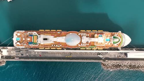 Cruise ship docked at port with stunning views of blue water and city