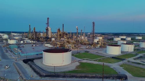 Cenovus Toledo Refinery at dusk with oil tanks and flare stacks in wide view