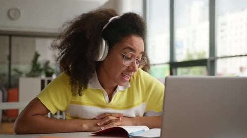 Young Woman in Online Meeting with Laptop