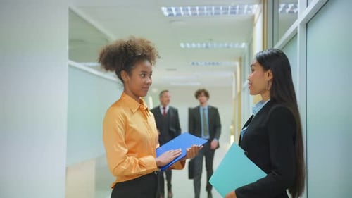 Professional businesswoman talking while stand on corridor in office.