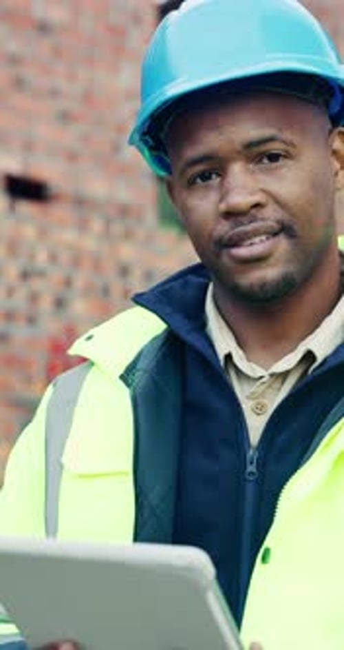 Tablet, black man and face on construction site with smile for building, renovation or repairs