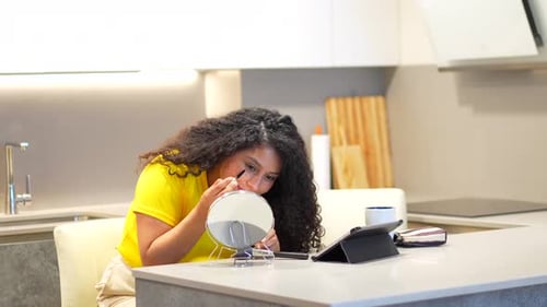 Mujer haciendo las paces sola en casa mirando un vídeo tutorial