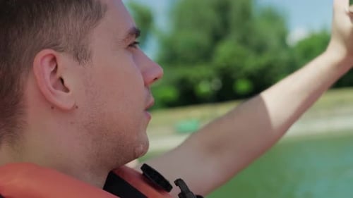 Young Man Wearing Life Vest on the Water