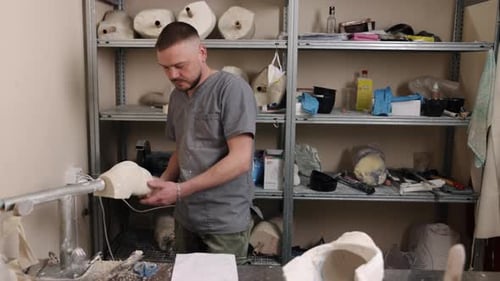 Craftsman Creating Prosthetic Leg in Bright Workshop