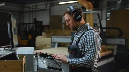 CNC Machine Operator Controls Cutting Process