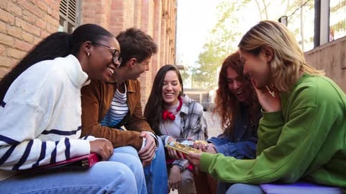 Group of Friends Laughing While Looking at Smartphone