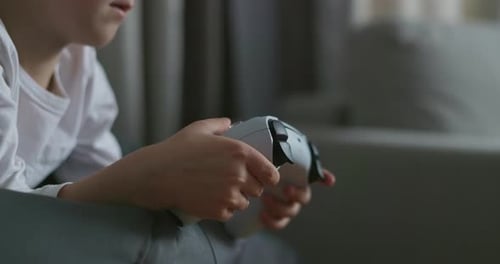 Child Playing with White Game Controller