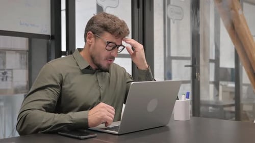 Man Working at Computer in Office Gets Frustrated